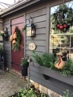 a house decorated for christmas with pomegranates and greenery