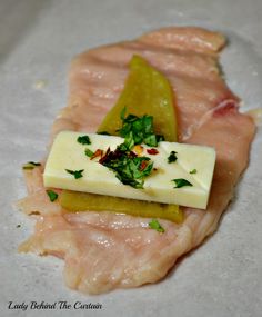 raw fish fillets with cheese and herbs on them