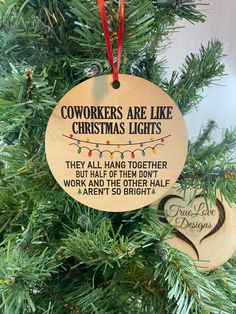 two christmas ornaments hanging from a tree with the words, workers are like christmas lights they all hang together but half of them don't