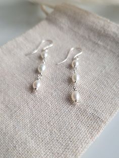 Thank you for looking at these beautifully delicate pearl drop earrings.  Pearls are a very popular jewellery item and a timeless choice for bridal jewellery or special occasions. These are one of my favourite items and I hope you love them too!  Now also available in gold: https://daintyrosebyalice.etsy.com/listing/1594939853 DETAILS: - Made with grade A 4mm freshwater pearls and recycled sterling silver wire.  - Pearls are a birthstone for June and associated with peace and faith.  - Wrapped o Dainty Silver Earrings Dangle, Pearl Drop Earrings Silver, Silver And Pearl Jewelry, Grad Jewelry, Pearl Jewelry Silver, Delicate Pearl Earrings, Silver Pearl Drop Earrings, Bridal Pearl Earrings, Silver Pearl Jewelry