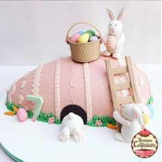 there is a cake that has been decorated with bunnies and other things on it