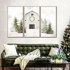 a living room with green couches and christmas tree in the corner, two paintings on the wall