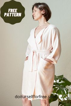 a woman standing in front of a potted plant wearing a pink robe and heels