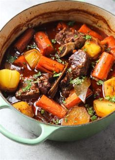 a pot filled with beef stew and carrots