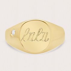 a yellow gold signet ring with the word blkr engraved in cursive font