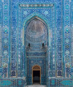 the entrance to an ornate building with blue and white tiles on it's walls