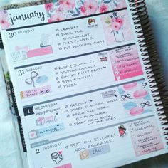 an open planner with pink flowers on it