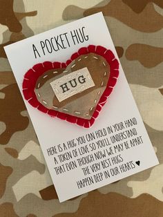 a card with a heart shaped object on it's side and the words, a pocket hug here is a wish you can hold in your hand