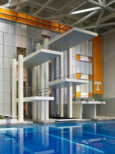 an indoor swimming pool in front of a large building with multiple levels and balconies