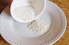 two white bowls filled with food on top of a plate