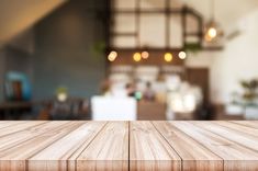 an empty wooden table top in front of a blurry background