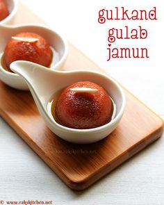 two small bowls filled with food on top of a wooden tray