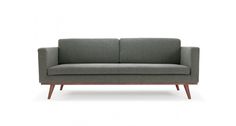 a gray couch with wooden legs on a white background