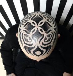 a man with a black and white design on his head