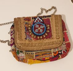 A truly exceptional tribal antique handbag, a one-of-a-kind piece. Bursting with vibrant colours, it's the perfect accessory for any occasion, whether a lively party or a casual day out. Made up of beads and wool. Perfect for your wardrobe or a gift. Has zip to close the bag. Length 11 inches by width: 9 inches Traditional Handmade Shoulder Bag For Party, Bohemian Clutch With Handwork, Bohemian Clutch Shoulder Bag For Festivals, Bohemian Multicolor Bags For Gifts, Bohemian Embroidered Clutch Bag, Bohemian Rectangular Clutch For Festival, Bohemian Multicolor Embroidery Bags As Gifts, Bohemian Clutch With Handwork As A Gift, Bohemian Multicolor Rectangular Clutch