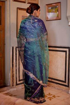 Blue and green two tone tissue saree with floral embroidery details. Comes with a blouse piece.
Component: 2
Pattern: Embroidery
Type Of Work: Floral
Fabric: Saree: Tissue; Blouse Piece: Embroidered Brocade
Color: Blue,Green
Other Details: 
Embroidered cut-out border detailing
Floral motifs
Note: The stitched blouse shown in the images is not for sale
Occasion: Wedding - Aza Fashions Blue Floral Saree, Floral Saree, Tissue Saree, Embroidered Saree, Blue Saree, Wedding Prep, Pattern Embroidery, Floral Motifs, Embroidery Details