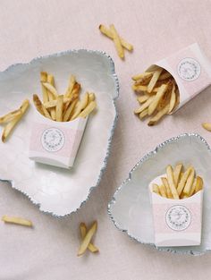 french fries are sitting in small bowls on a table