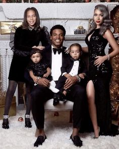 a family posing for a christmas photo in front of a fireplace