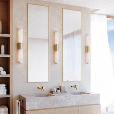 a bathroom with two sinks, mirrors and towels on the shelves in front of it