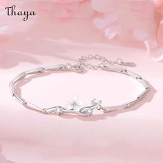 This striking Cherry Blossom Silver Bracelet is inspired by the symbolic beauty of Japan's national flower, the cherry blossom. The delicate and intricate design of the bracelet perfectly captures the fleeting nature of the blossom, making it a meaningful and symbolic piece of jewelry. Made from high-quality silver, it is perfect for daily wear, special occasions, or as a thoughtful gift.   - Brand: Thaya  - Material: 925 silver + Zircon+White shell  - Size: 14.5 + 3cm   - Style: Flower  - Gender: Women's Elegant Spring Bracelet With Flower Charm, Elegant Spring Bracelets In Flower Shape, Delicate Spring Bracelet Jewelry, Elegant Flower-shaped Bracelets For Spring, Elegant Floral Bracelet For Spring, Elegant Spring Flower-shaped Bracelets, Elegant Silver Bracelets For Spring, Elegant Silver Bracelet For Spring, Elegant Spring Bracelets As A Gift