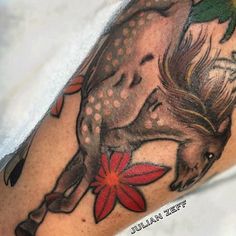 a close up of a person's arm with a tattoo on it and a horse