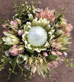 a bouquet of flowers is shown in front of a wall