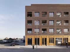 a tall brick building sitting next to a parking lot