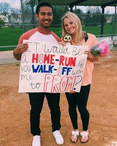 a man and woman holding a sign that says i would be home run walk off prom