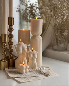 some candles are sitting next to each other on a table