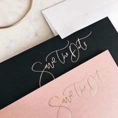 two different types of wedding cards with gold lettering on them, one in black and the other in pink