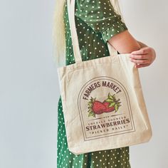 "Take your farmers market bag everywhere! It's not just perfect for the market for your fruits and vegetables. This strawberry tote bag is a perfect book bag or library bag. Use it as your lunch bag in any setting. It also makes for darling teacher tote bags as the school year ramps into gear.  This 100% cotton bag comes in one size - 15\" x 16\"- perfect for everyday wear. While the canvas material will show off your designs in great colors, it's durable and will last for years. The bag features 20\" handles (made from the same canvas), making it easy to carry even with a week's worth of shopping. .: 100% cotton canvas .: Heavy fabric (12 oz/yd² (406.9 g/m .: Sewn-in label If you would like our designs printed on a product not shown, please message us. We are happy to put these designs on Casual Reusable Grocery Bags, Everyday Organic Rectangular Bag, Organic Rectangular Canvas Bag For Everyday Use, Organic Tote Bag For Daily Use, Eco-friendly Rectangular Canvas Bag For Groceries, Eco-friendly Tote Bags For Grocery Shopping, Eco-friendly Rectangular Canvas Grocery Bag, Eco-friendly Tote Bags For Grocery, Organic Tote Bag For Shopping