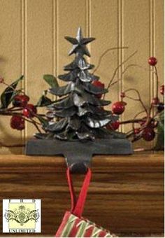 a metal christmas tree sitting on top of a wooden table