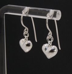 These terrific heart dangle earrings are cast from a wax carved original and are cast using the lost wax process. I then make a mold, then a wax copy, and through the process of lost wax casting I make these cast earrings in sterling silver. These sweet heart sterling silver earrings are patinaed, pin polished, and given a light polish for a bright shimmer. Hung with handmade sterling french hooks. 20mm x 10 mm Made to Order. Ready to ship in 1-3 days. Hand Cast Sterling Silver Earrings, Silver Hand Cast Dangle Earrings, Hand Cast Silver Dangle Earrings, Handmade Sterling Silver Heart Pendant Earrings, Hand Cast Sterling Silver Drop Earrings, Handmade Sterling Silver Teardrop Heart Earrings, Handmade Teardrop Sterling Silver Heart Earrings, Handmade Teardrop Heart Earrings In Sterling Silver, Silver Sterling Silver Heart Charm Earrings