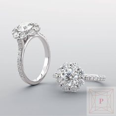 an engagement ring with two diamonds on the side and one diamond in the middle, sitting next to each other