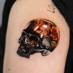 a skull with flowers painted on it's side