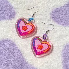 Rainbow heart earrings! 🌈  Finished with a glitter epoxy layer ✨  Nickel free hooks, silver plated Multicolor Heart-shaped Kawaii Jewelry, Kawaii Multicolor Heart-shaped Jewelry, Cute Multicolor Heart Charm Earrings, Cute Multicolor Earrings With Heart Charm, Cute Resin Heart Earrings For Valentine's Day, Cute Heart Dangle Earrings With Ear Wire, Cute Dangle Heart Earrings With Ear Wire, Cute Heart Print Jewelry, Kawaii Heart-shaped Earrings For Valentine's Day