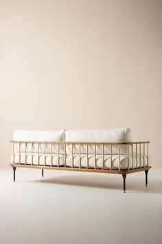 a white couch sitting on top of a wooden frame