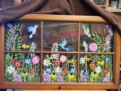 the window is decorated with flowers and birds