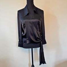 Excellent Pre-Owned Condition Indulge In Sophisticated Style With This Escada Black Wrap-Around Blouse. Designed In Luxurious 100% Silk, It Features A Classic Wrap-Around Enclosure, A Chic Collar, And A Flattering V-Neck. The Crystal Button Cuffs Add A Touch Of Refined Glamour, Making This Size 8 Blouse A Perfect Choice For Both Elegant And Professional Settings. Elevate Your Wardrobe With This Timeless Piece That Exudes Effortless Luxury. Features Size: Us 8 / Euro 40 Style: Mature Lightweight Designer Long Sleeve Blouse For Evening, Designer Fitted Blouse For Night Out, Designer Long Sleeve Blouse For Night Out, Fitted Tops With Button Cuffs For Night Out, Designer Fitted Evening Blouse, Classic Long Sleeve Evening Blouse, Classic Long Sleeve Blouse For Evening, Evening Tops With Button Cuffs, Elegant Tops With Button Cuffs For Night Out