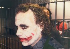 a man dressed as the joker in a jail cell