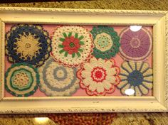 there are many crocheted flowers in the frame