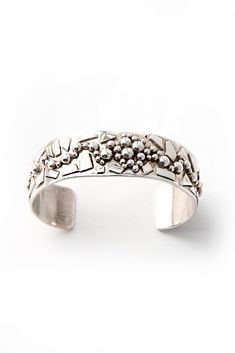 North Carolina artist, Benjamin Forest combines elements from his "Silver Shards" and "Pebbles" designs to create a gorgeous contemporary heavy sterling silver bracelet. Each handmade shard and pebble is individually soldered to the bracelet in a one-of-a-kind pattern. It is stamped "Sterling" and hallmarked by the artist. Matching pieces are available. Fits 6.5" wrist, adjustable Contemporary Sterling Silver Bracelet, Contemporary Polished Sterling Silver Bracelet, Contemporary Sterling Silver Bracelet With Polished Finish, Unique Polished Sterling Silver Bracelet, Unique Sterling Silver Cuff Bracelet, Contemporary Sterling Silver Bracelet In Silver, Handmade Silver Modernist Bracelets, Handmade Contemporary Silver Bracelet, Contemporary Handmade Silver Bracelet