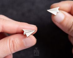 "✨ Origami earrings measuring only 1.4 x 1.1 cm ✨ The stud earrings from wood with a stainless steel base ✨ Those tiny paper airplanes are processed within 1-3 business days 🌟 Take a whimsical journey with our origami paper airplane funky earrings! These cute and minimalist Japanese earrings, measuring 1.4 x 1.1 cm (1/2\" x 3/8\"), are a delightful addition to your accessory collection and make a perfect travel inspired gift. Crafted with intricate precision, each stud captures the playful essence of an origami paper airplane, adding a touch of whimsy and creativity to your style. These funky earrings are a perfect way to express your love for travel and adventure. hether you're an avid traveler or simply appreciate the art of origami, our origami paper airplane funky earrings are sure to Paper Airplane Earrings, Funky Stud Earrings, Japanese Earrings, Origami Earrings, Minimalist Japanese, Paper Airplane, Funky Earrings, Paper Airplanes, Small Jewelry Box