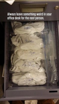 there is a drawer full of white shirts with writing on the bottom, and an image of someone's feet in it