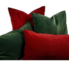 three red and green pillows sitting next to each other