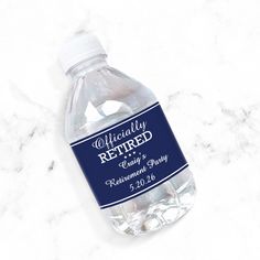 a bottle of personalized bottled water on a marble countertop with the label removed