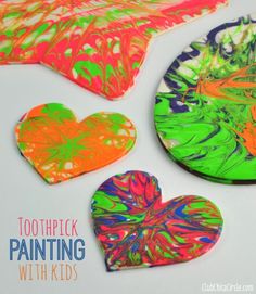 three heart shaped paper plates with different colors on them and the words toothpick painting with kids