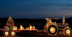 a tractor decorated with christmas lights and trees