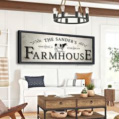 a living room filled with furniture and a painting on the wall above it that says, the sander's farmhouse