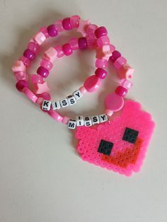 This Kissy Missy themed bracelet set makes the perfect addition to an outfit or cosplay!  Bracelets are around 7 inches circumference but will fit a variety of wrist sizes. Bracelets are made with pony beads, perler beads, letter beads, and elastic cord. Be sure to check out the other themed bracelet sets in my shop! Themed Pink Bracelets As A Gift, Pink Themed Bracelet As Gift, Handmade Plastic Novelty Beaded Bracelets, Handmade Novelty Plastic Beaded Bracelets, Themed Pink Bracelet Gift, Pink Novelty Plastic Bracelets, Pink Plastic Novelty Bracelets, Pink Novelty Beaded Bracelets, Pink Handmade Themed Bracelets